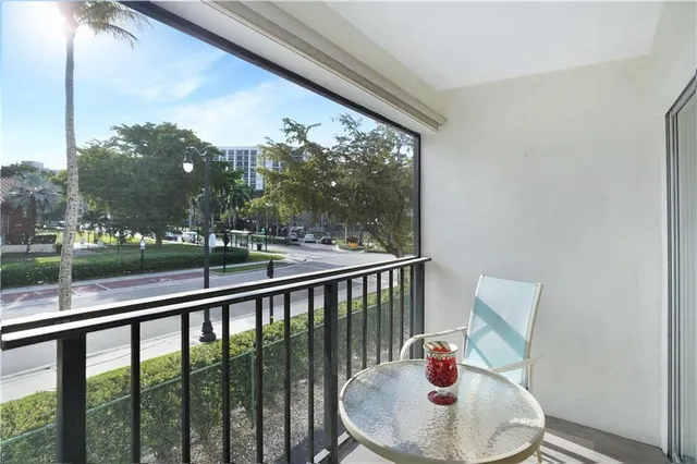 a view of a porch with furniture and a yard