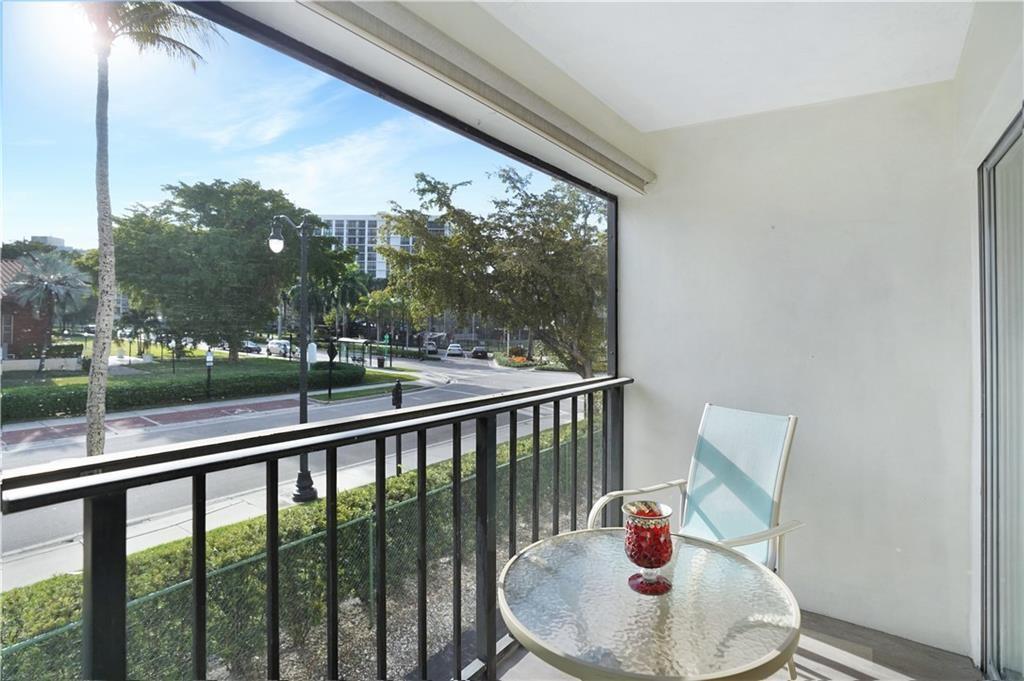Undisclosed Address Sunny Isles Beach, FL 33160 - Photo 4 of 7 a view of a porch with furniture and a yard