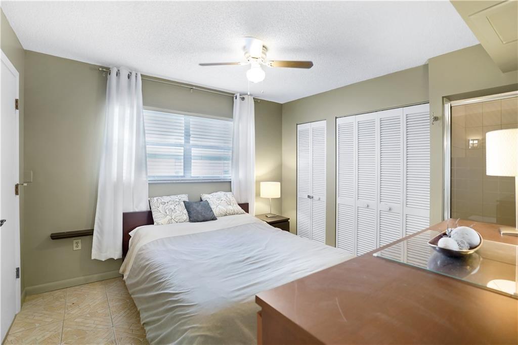 Undisclosed Address Sunny Isles Beach, FL 33160 - Photo 6 of 7 a bedroom with a bed and a chandelier