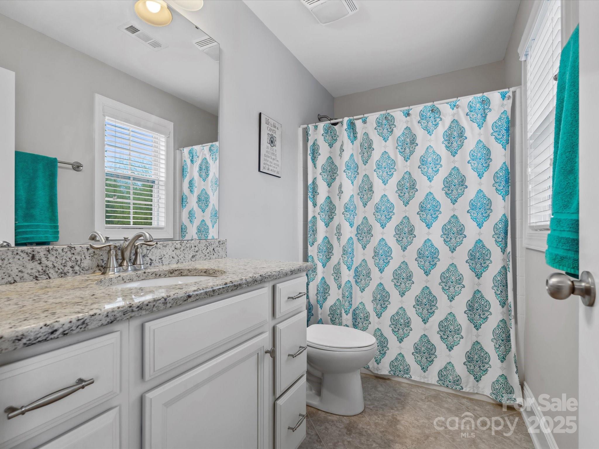 130 Villa Lake Drive Fort Mill, SC 29708 - Photo 24 of 46 a bathroom with a granite countertop sink a toilet and a shower