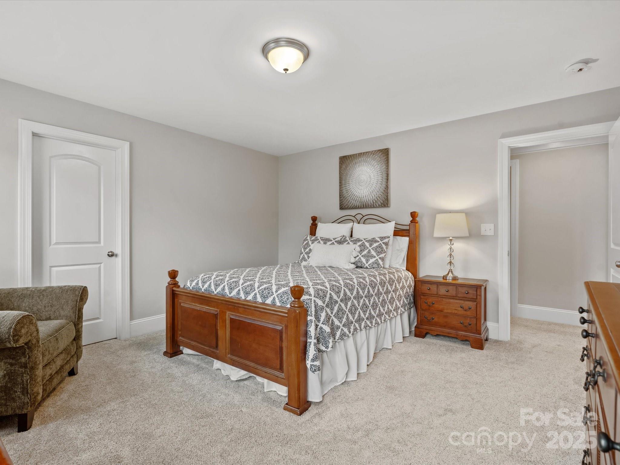 130 Villa Lake Drive Fort Mill, SC 29708 - Photo 25 of 46 a bedroom with a bed and a lamp