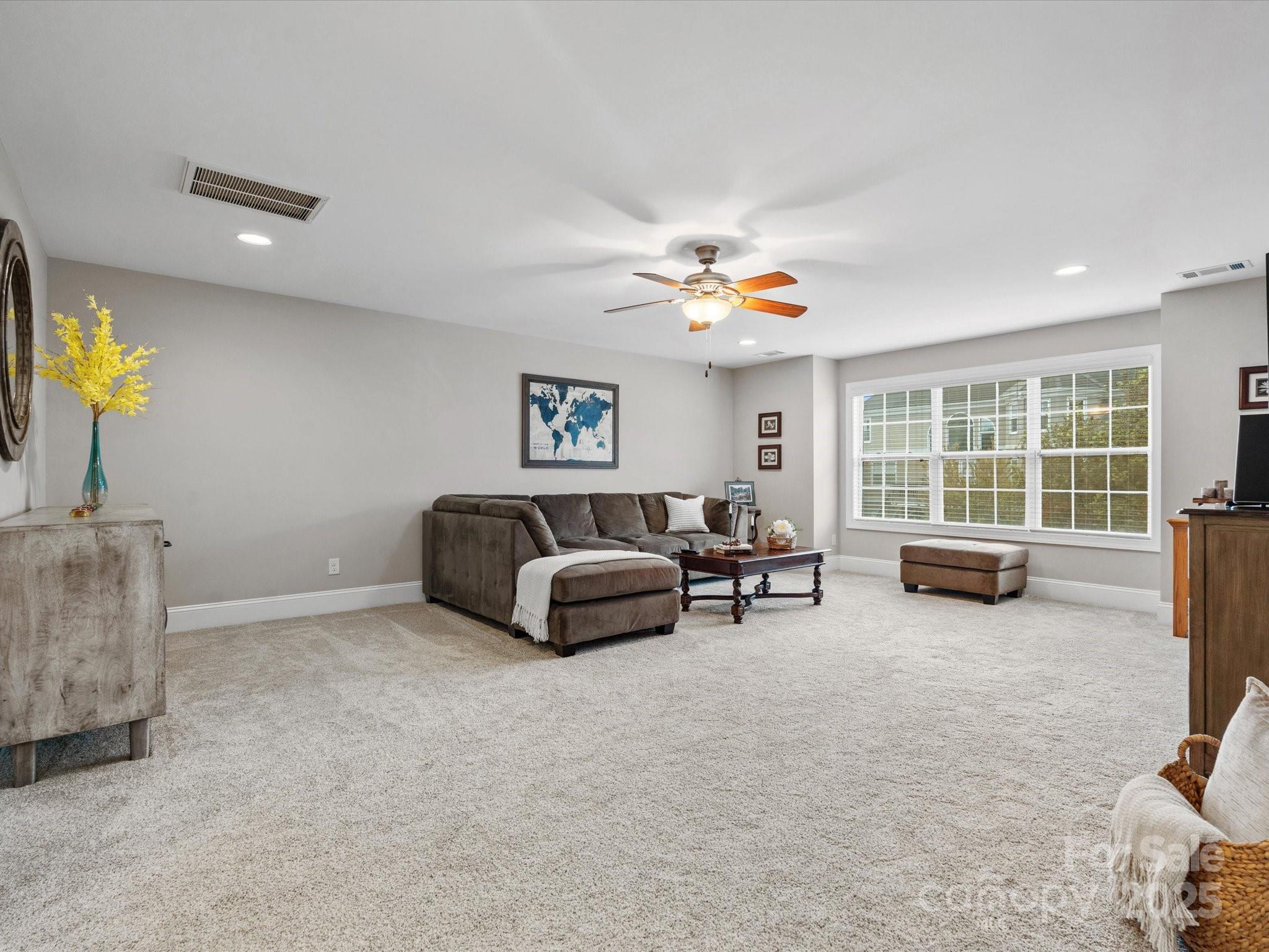 130 Villa Lake Drive Fort Mill, SC 29708 - Photo 27 of 46 a living room with furniture and a flat screen tv