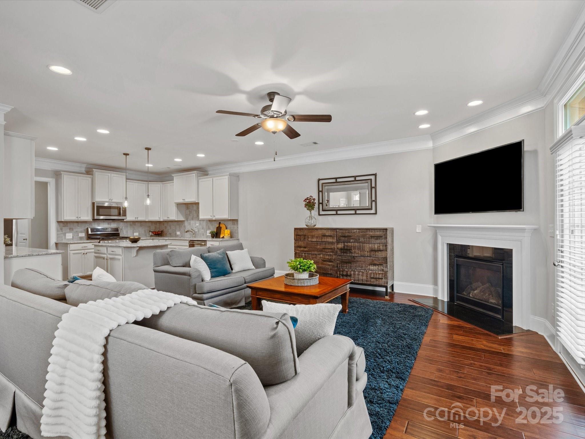 130 Villa Lake Drive Fort Mill, SC 29708 - Photo 9 of 46 a living room with furniture a fireplace and a flat screen tv