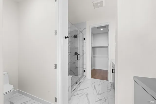 a bathroom with a shower and a toilet