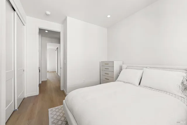 a bedroom with a bed and a night stand