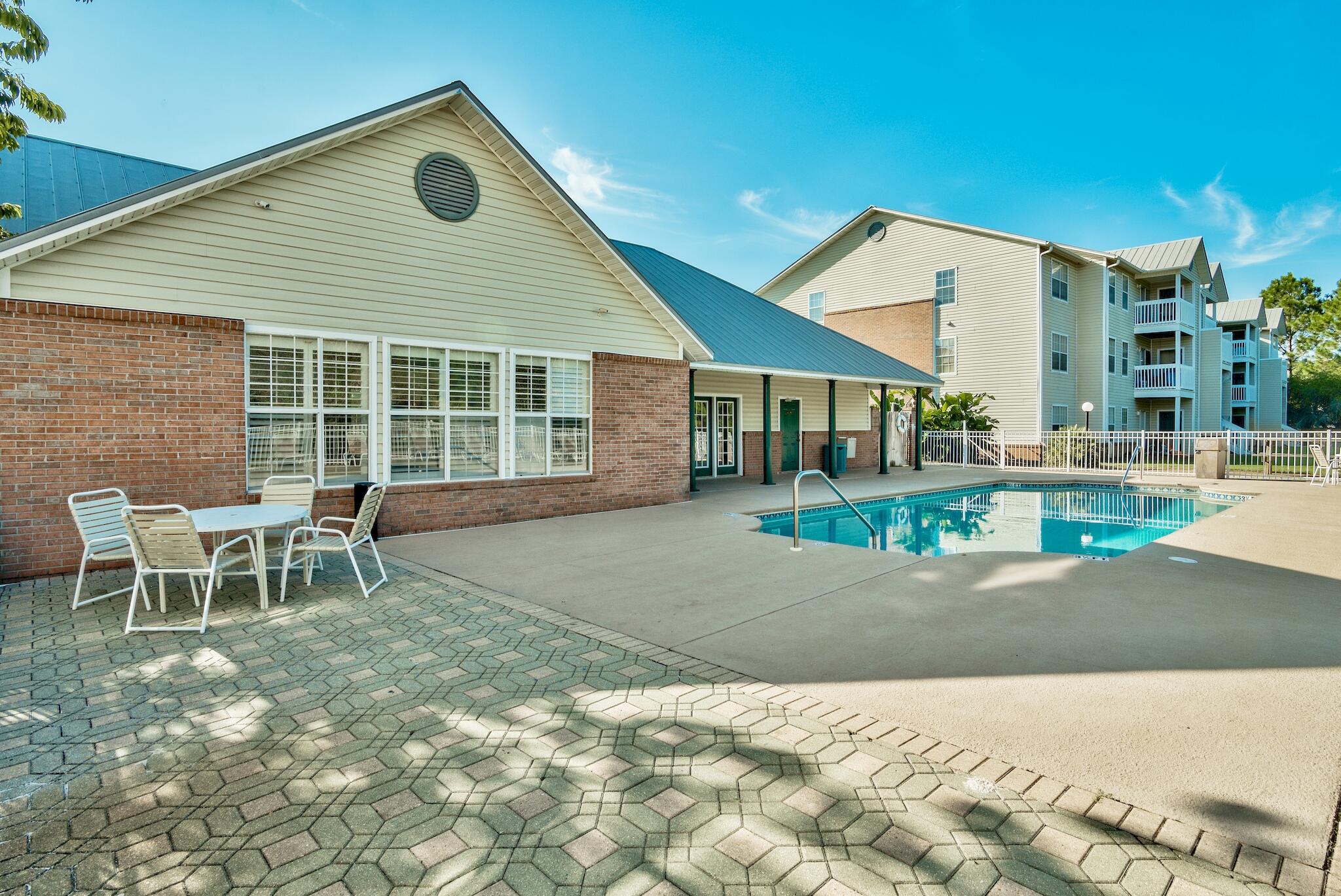 4070 Dancing Cloud Court, Unit 187 Destin, FL 32541 - Photo 13 of 20 a backyard of a house with table and chairs
