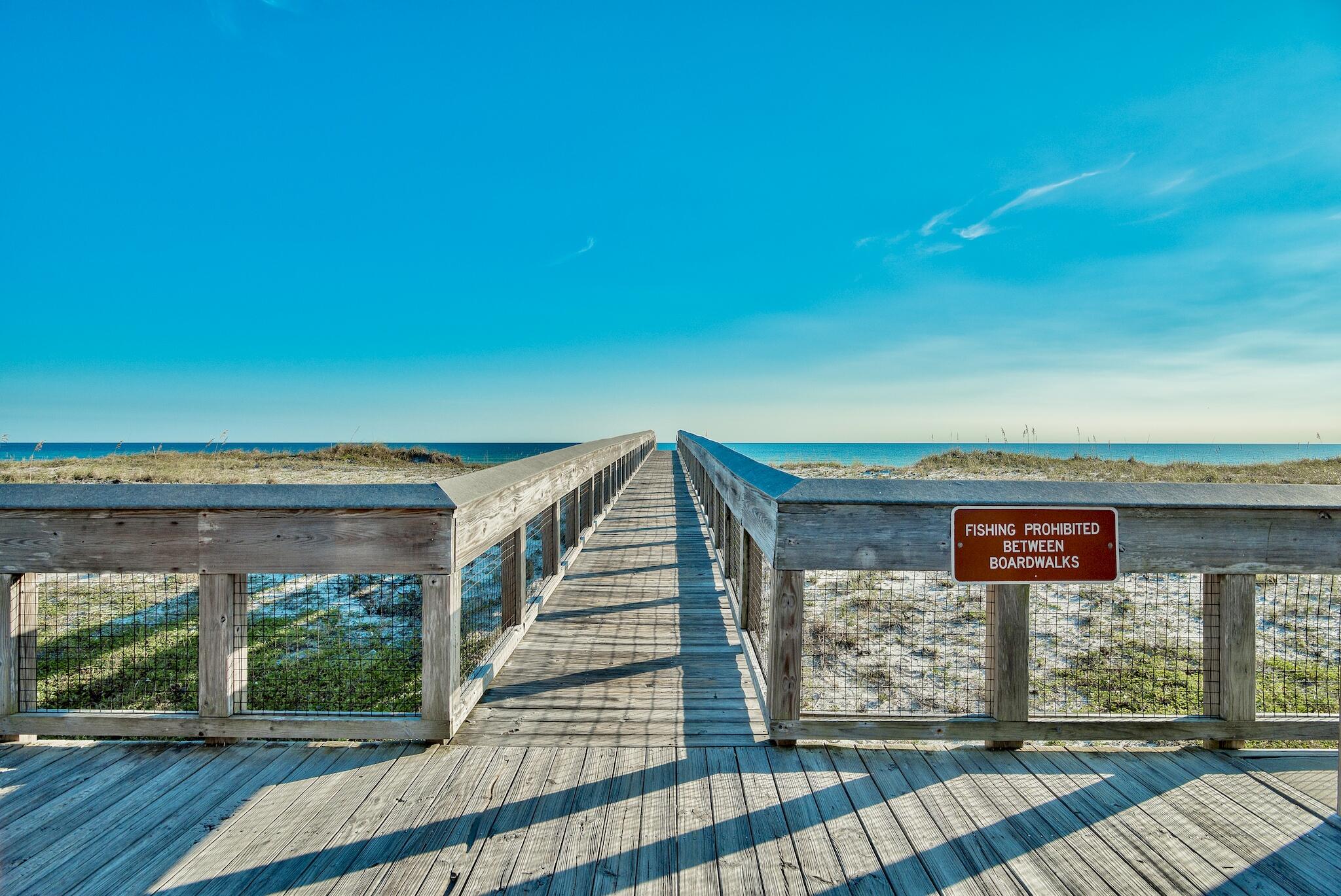 4070 Dancing Cloud Court, Unit 187 Destin, FL 32541 - Photo 17 of 20 a view of a porch with wooden floor and fence