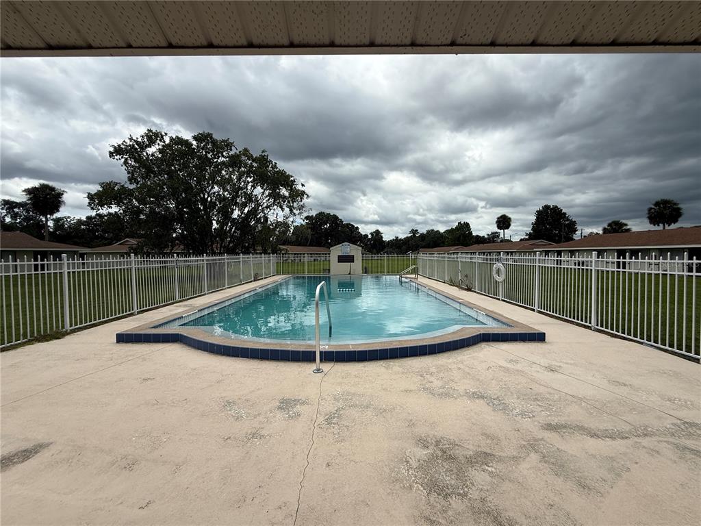 2744 Botts Landing Road, Unit 603 DeLand, FL 32720 - Photo 15 of 17 a view of a swimming pool with a patio