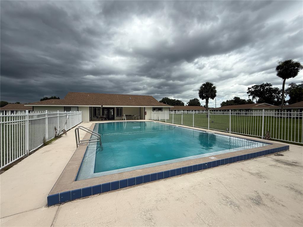 2744 Botts Landing Road, Unit 603 DeLand, FL 32720 - Photo 16 of 17 a view of a swimming pool and a yard