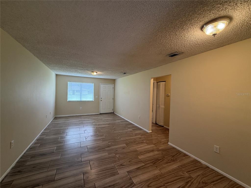 2744 Botts Landing Road, Unit 603 DeLand, FL 32720 - Photo 3 of 17 a view of empty room with wooden floor