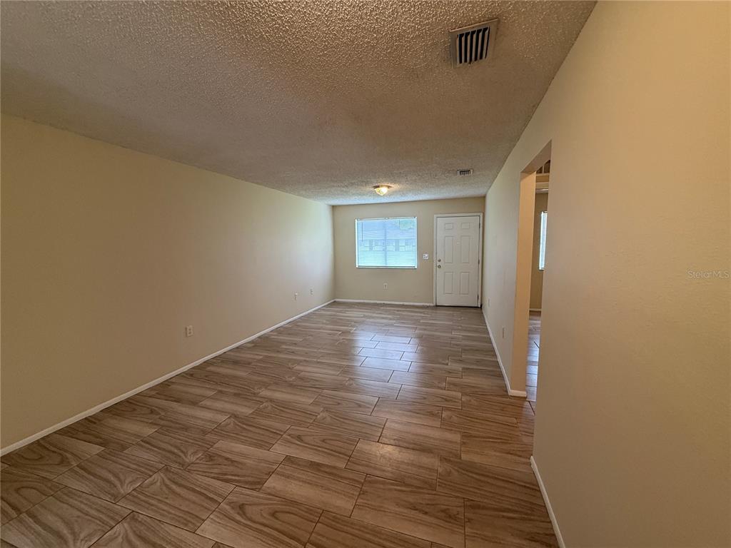 2744 Botts Landing Road, Unit 603 DeLand, FL 32720 - Photo 4 of 17 a view of wooden floor and windows in a room