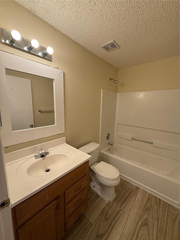 2744 Botts Landing Road, Unit 603 DeLand, FL 32720 - Photo 6 of 17 a bathroom with a sink a toilet a mirror and shower