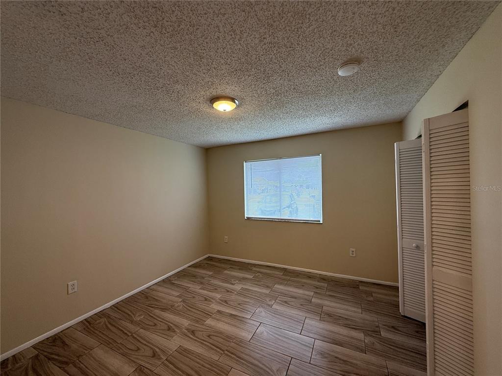 2744 Botts Landing Road, Unit 603 DeLand, FL 32720 - Photo 8 of 17 a view of an empty room with wooden floor and a window