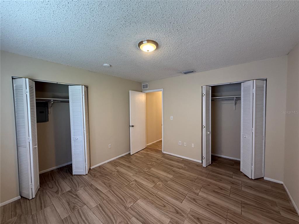 2744 Botts Landing Road, Unit 603 DeLand, FL 32720 - Photo 9 of 17 an empty room with wooden floor and closet