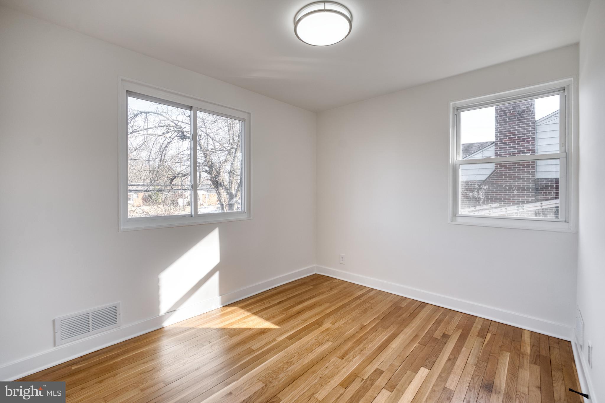 12214 Connecticut Avenue Silver Spring, MD 20902 - Photo 11 of 18 a view of empty room with wooden floor and fan
