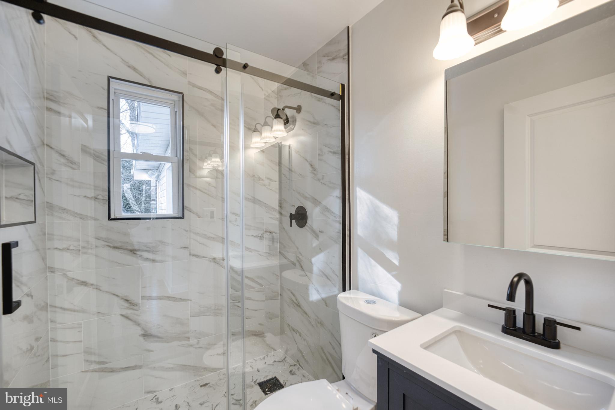 12214 Connecticut Avenue Silver Spring, MD 20902 - Photo 12 of 18 a bathroom with a sink and a mirror