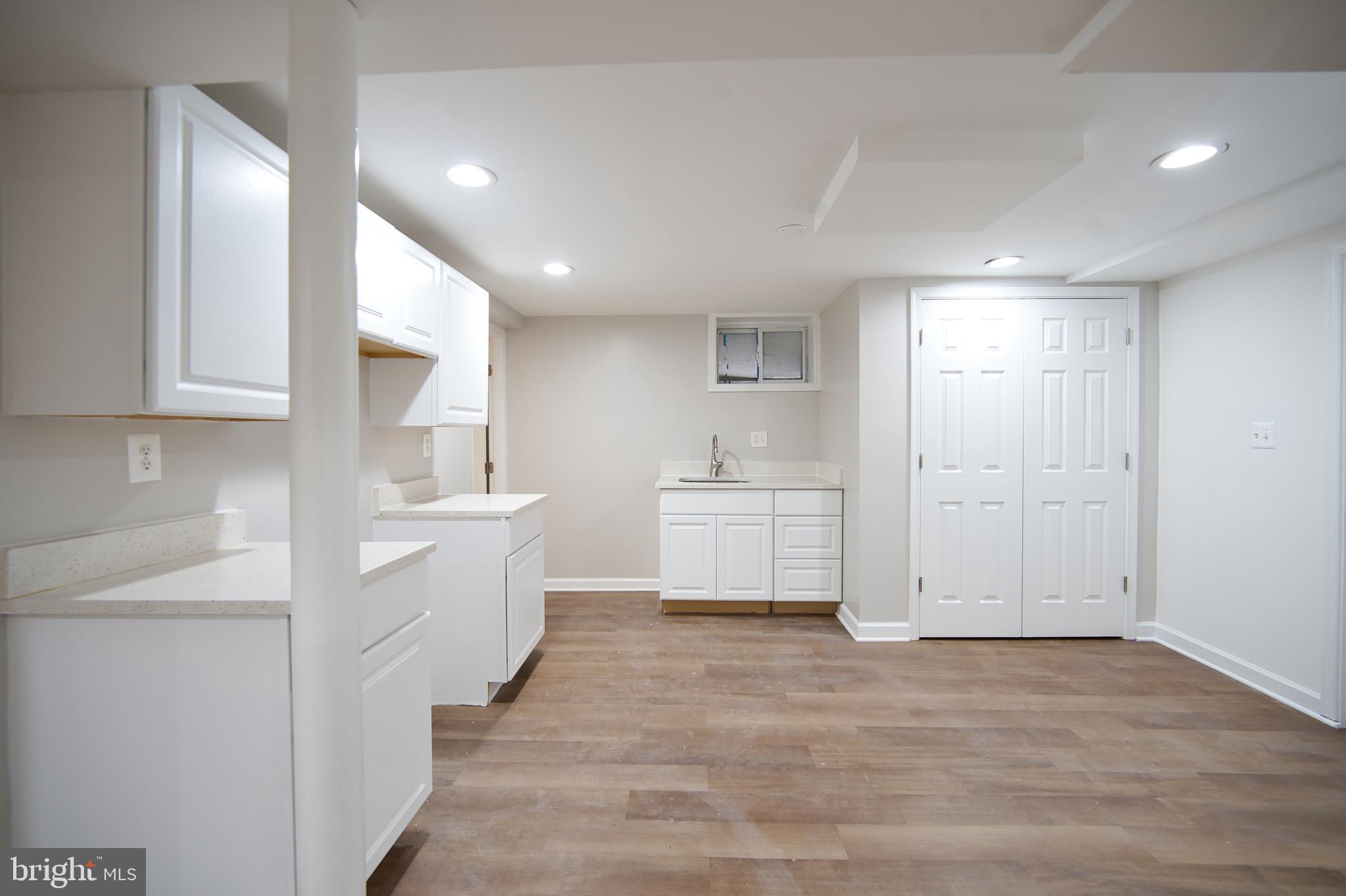 12214 Connecticut Avenue Silver Spring, MD 20902 - Photo 14 of 18 a view of a kitchen with white cabinets