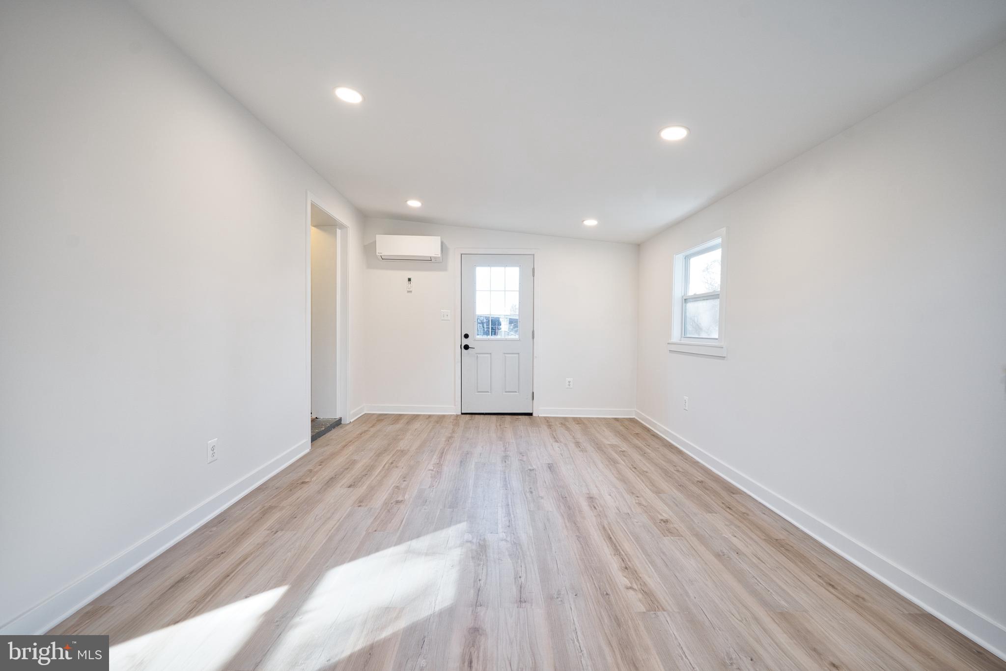 12214 Connecticut Avenue Silver Spring, MD 20902 - Photo 7 of 18 an empty room with wooden floor and window
