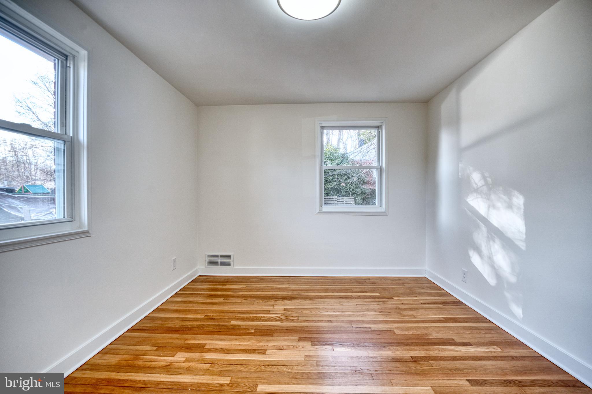 12214 Connecticut Avenue Silver Spring, MD 20902 - Photo 9 of 18 a view of empty room with wooden floor and fan