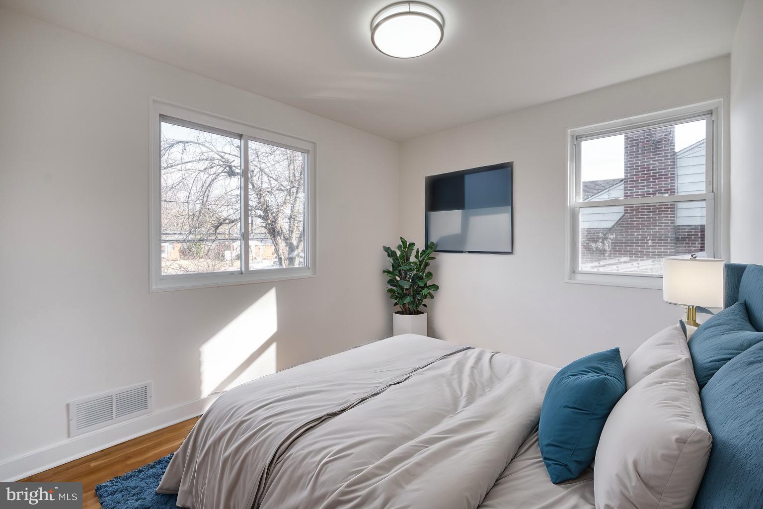 12214 Connecticut Avenue Silver Spring, MD 20902 - Photo 10 of 18 a bedroom with a bed and a window