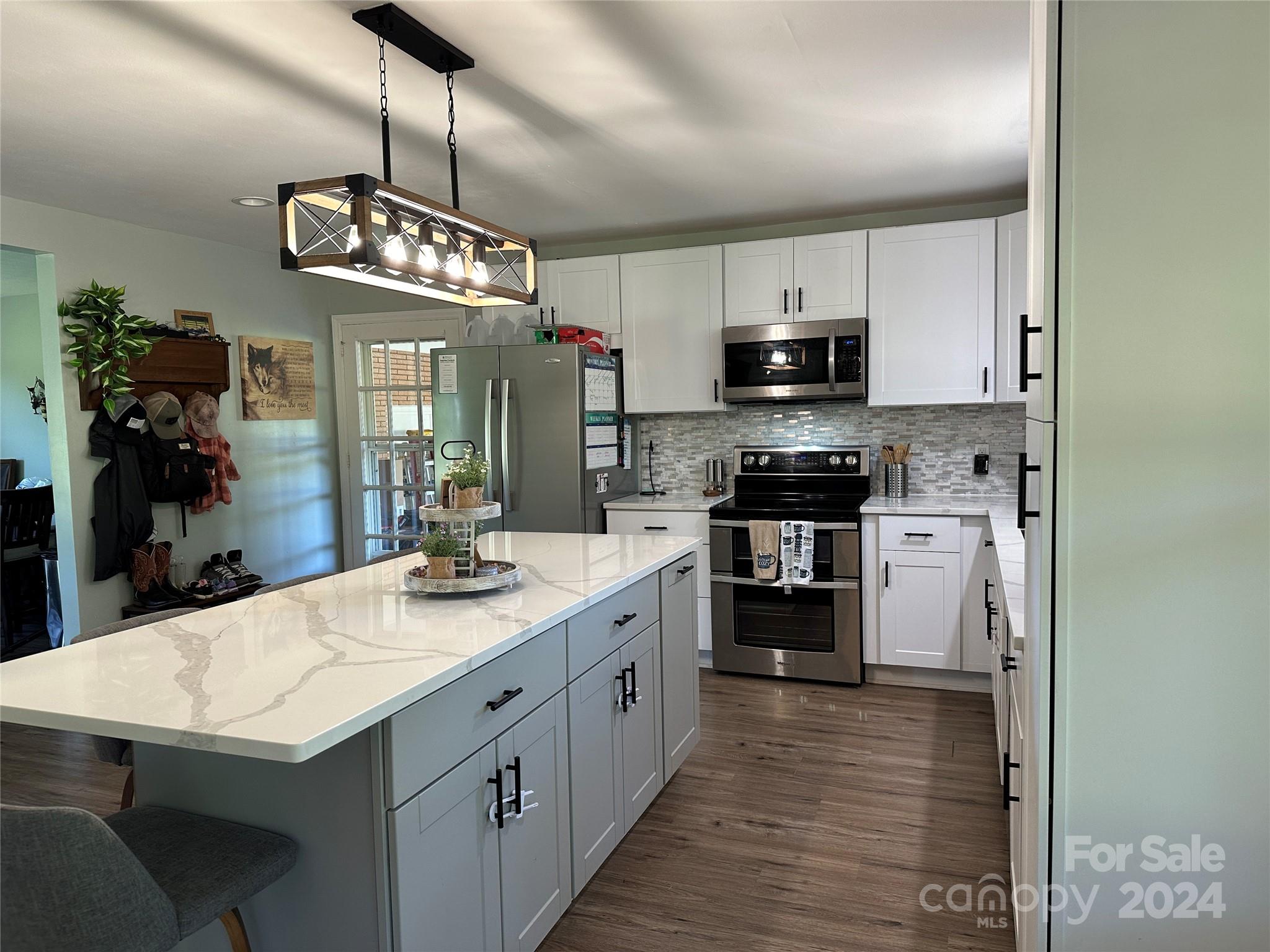 1118 Stack Road Monroe, NC 28112 - Photo 13 of 42 a kitchen with kitchen island granite countertop stainless steel appliances cabinets a sink and a counter top space