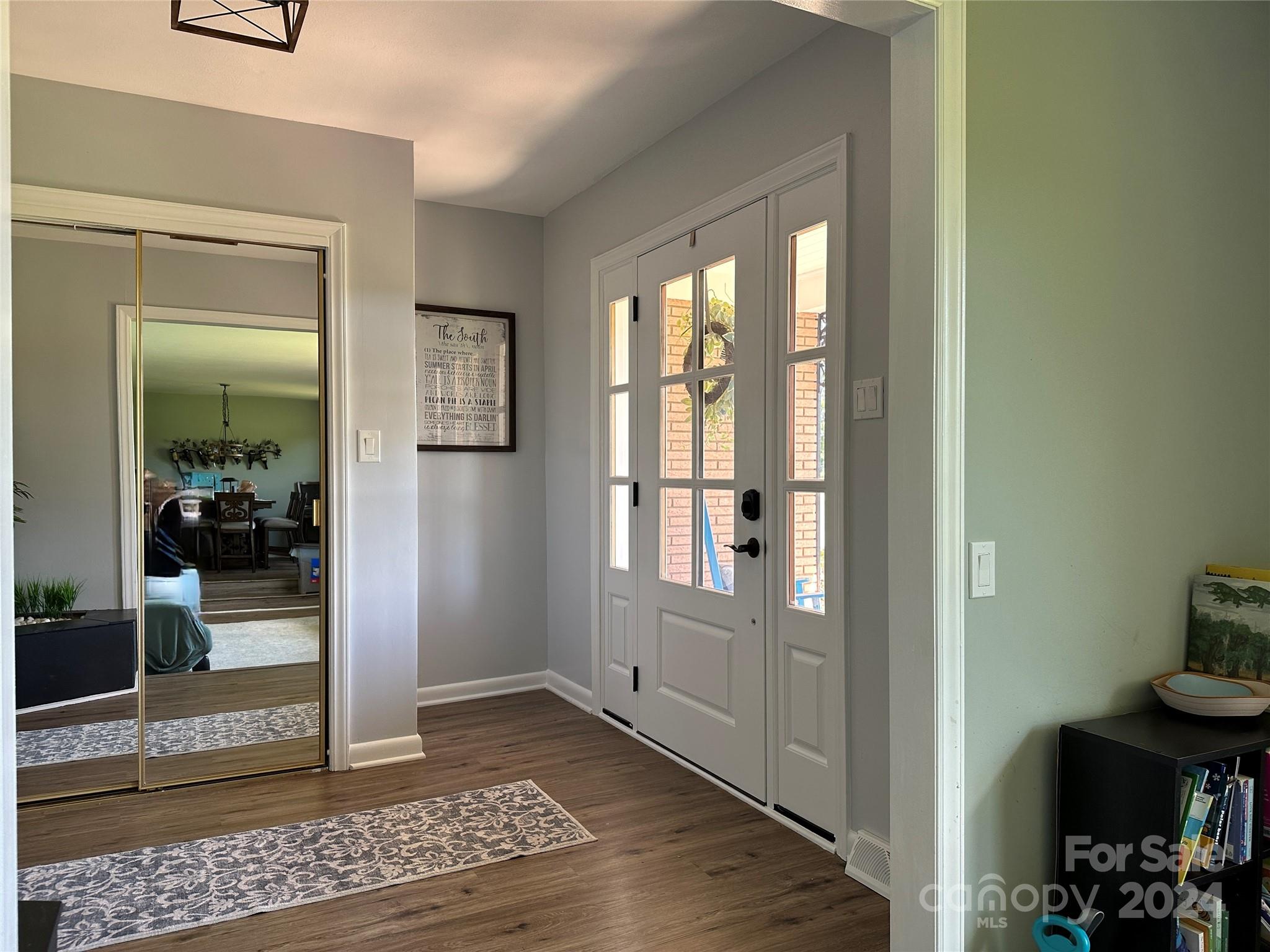 1118 Stack Road Monroe, NC 28112 - Photo 3 of 42 a view of a hallway with wooden floor and a livingroom