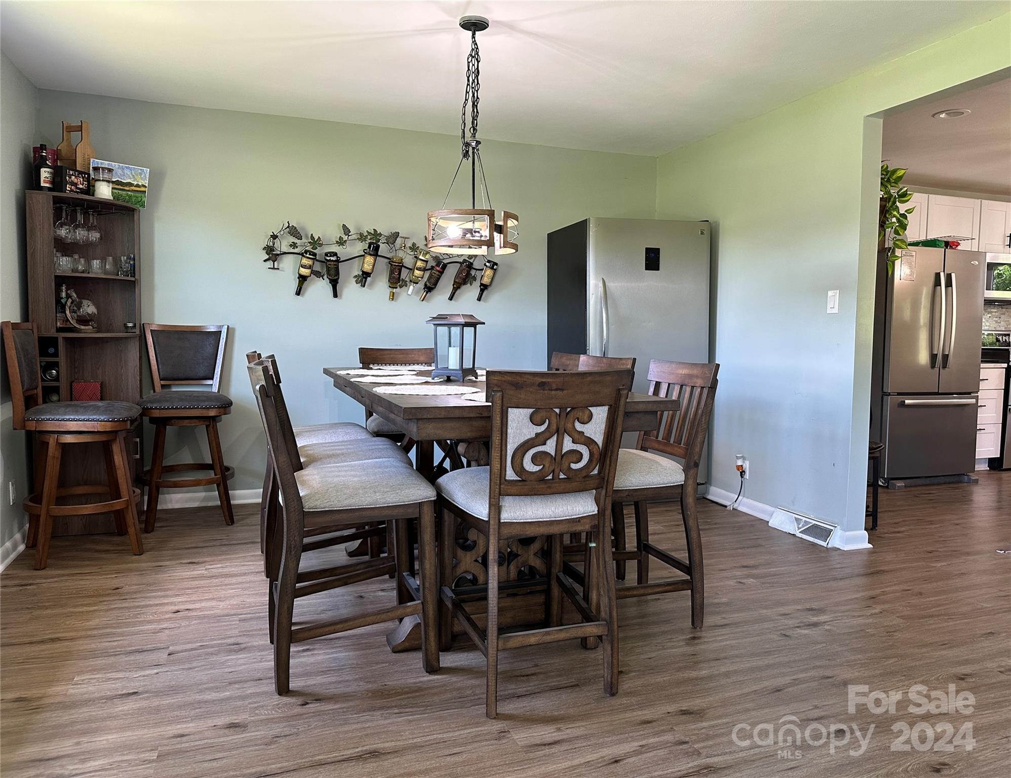 1118 Stack Road Monroe, NC 28112 - Photo 8 of 42 a dining room with furniture wooden floor a rug and a chandelier