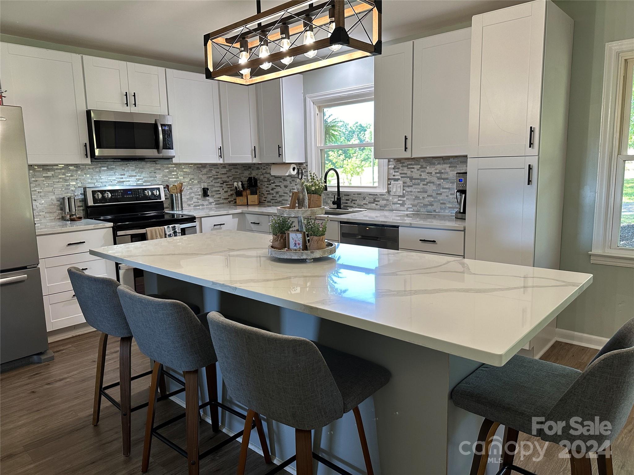 1118 Stack Road Monroe, NC 28112 - Photo 9 of 42 a kitchen with stainless steel appliances a table chairs sink and cabinets