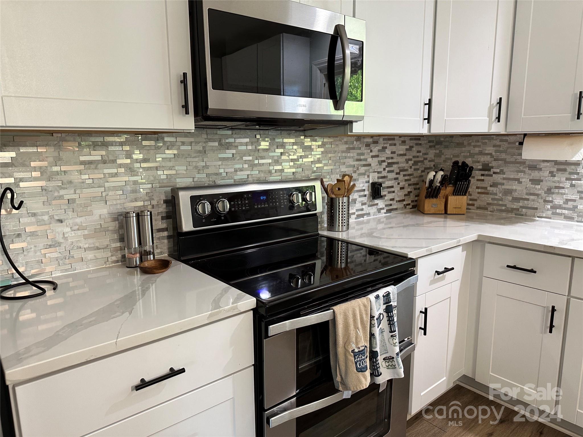 1118 Stack Road Monroe, NC 28112 - Photo 10 of 42 a kitchen with granite countertop a stove and a microwave