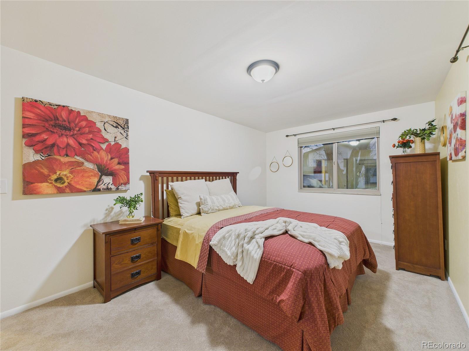 8373 Zephyr Street Arvada, CO 80005 - Photo 12 of 31 a bedroom with a bed and a window