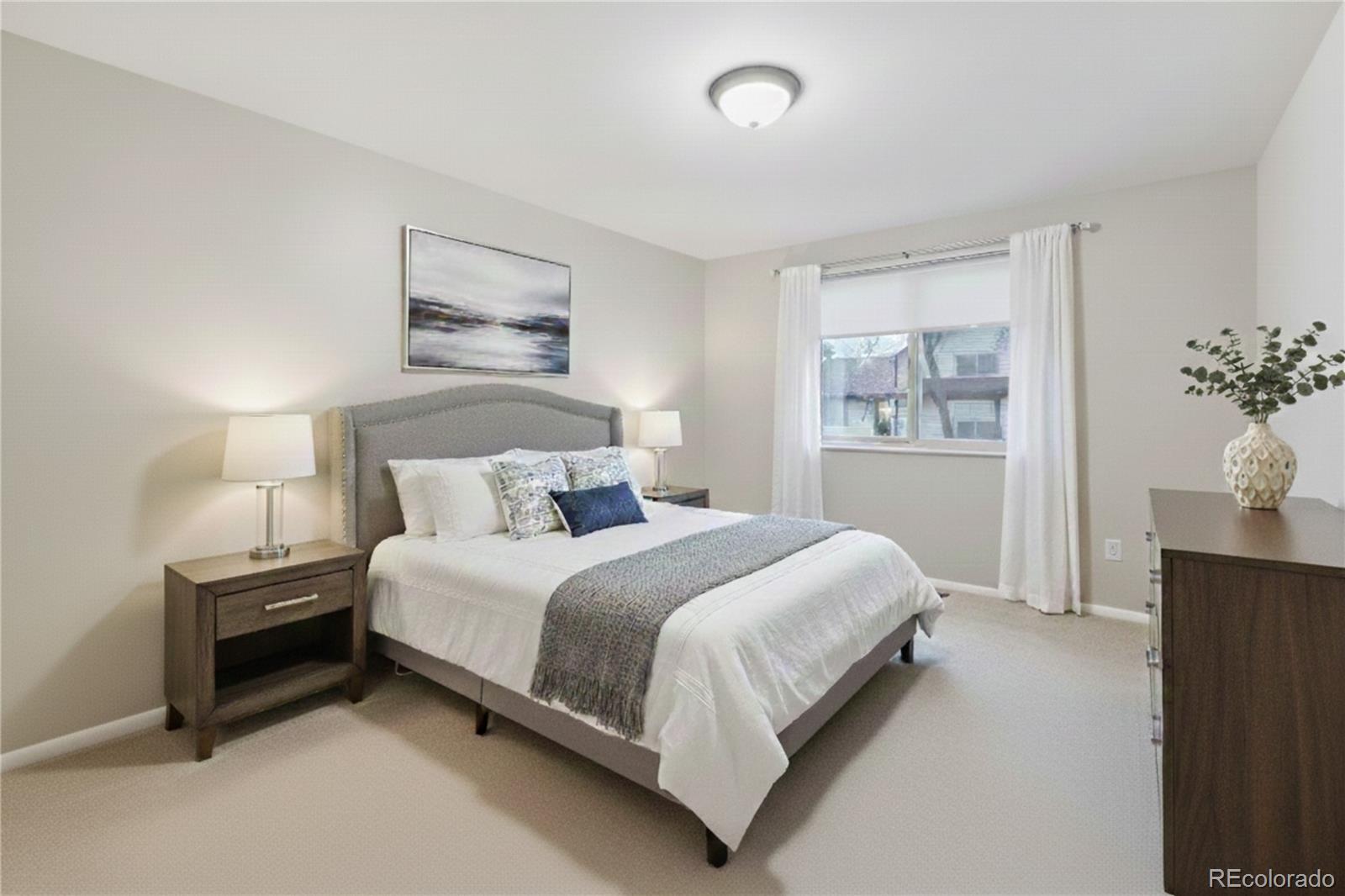 8373 Zephyr Street Arvada, CO 80005 - Photo 13 of 31 a bedroom with a bed and a painting on the wall