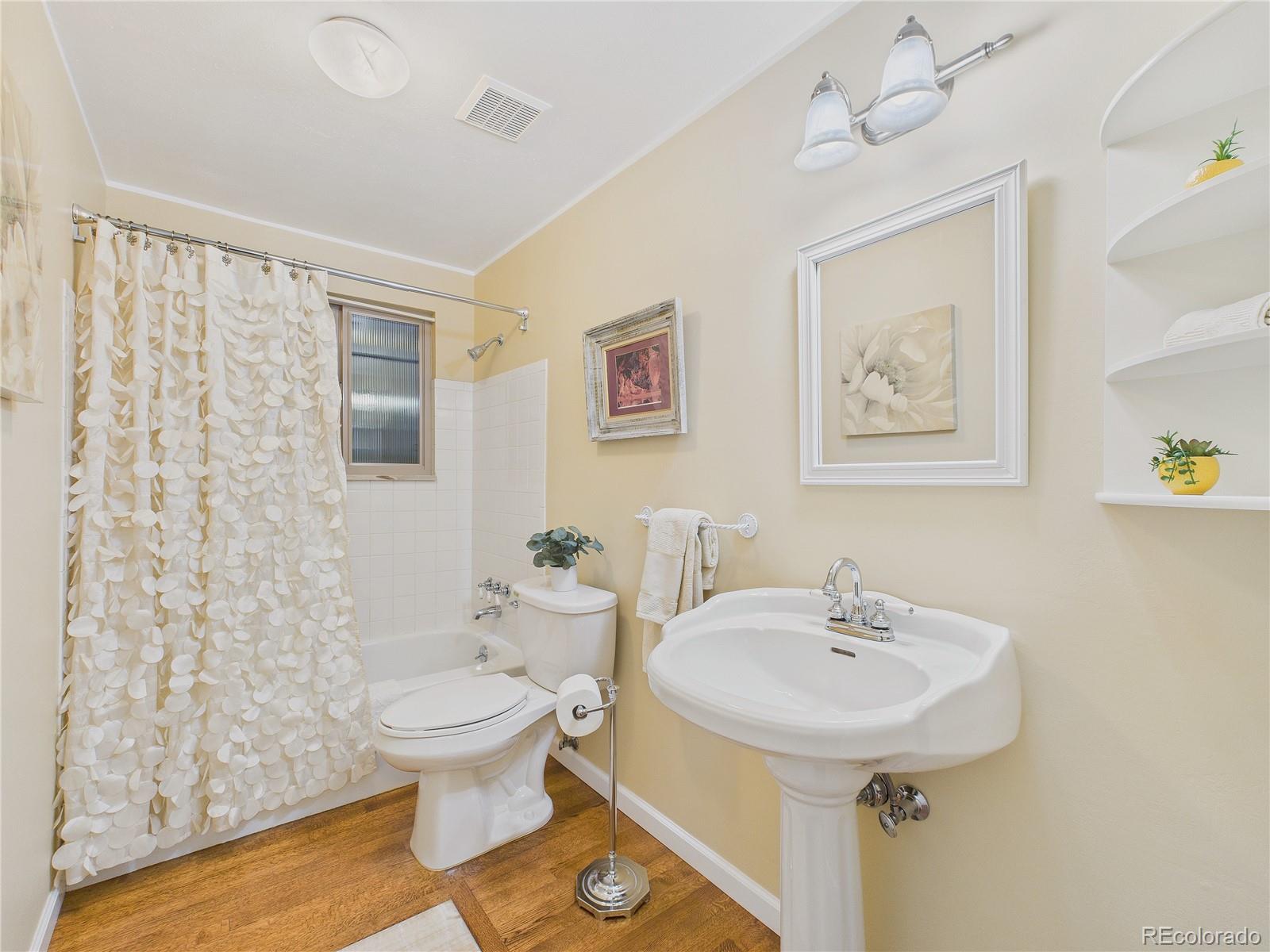 8373 Zephyr Street Arvada, CO 80005 - Photo 14 of 31 a bathroom with a sink toilet and shower