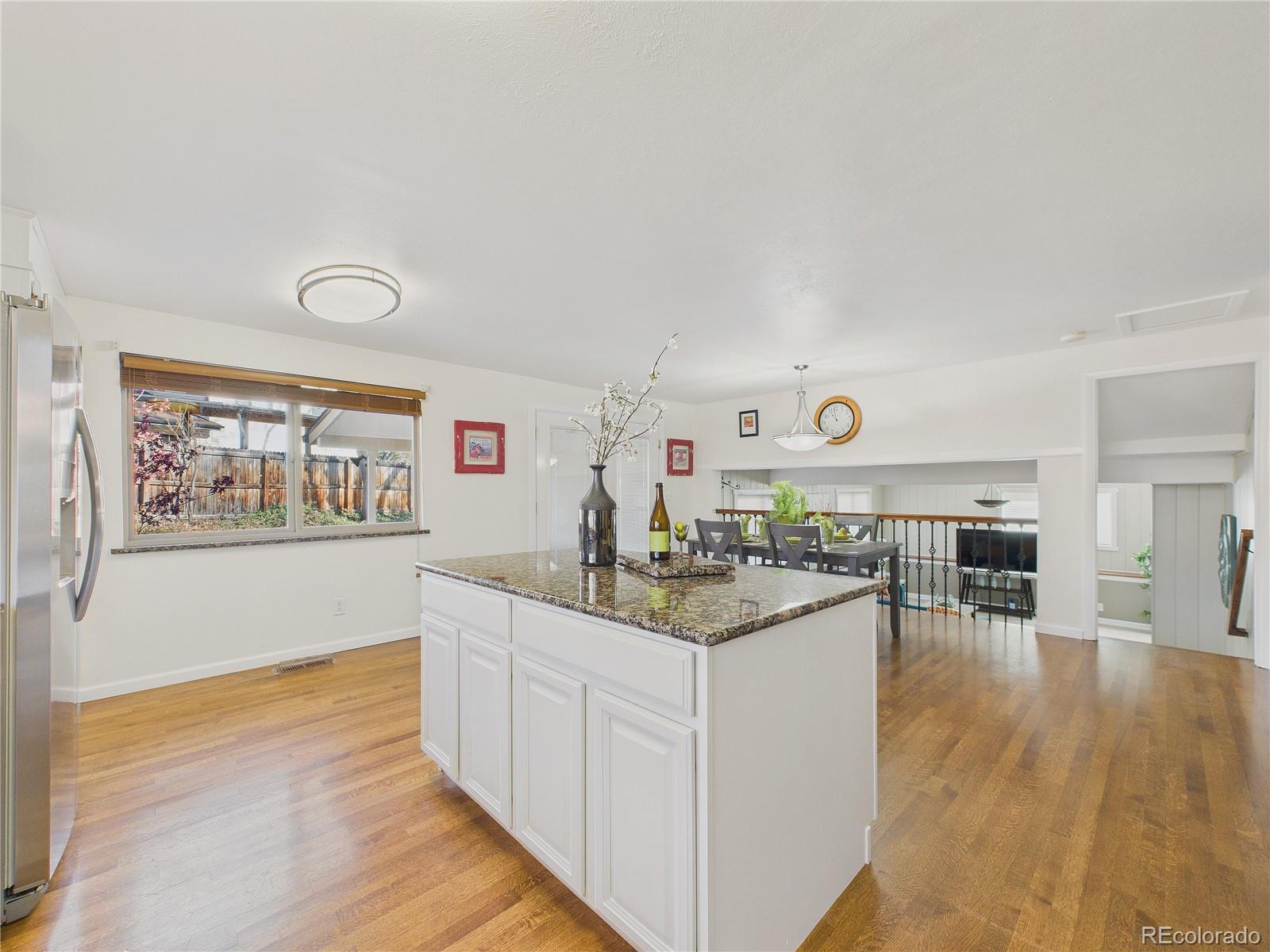 8373 Zephyr Street Arvada, CO 80005 - Photo 21 of 31 a kitchen with stainless steel appliances granite countertop a stove and cabinets