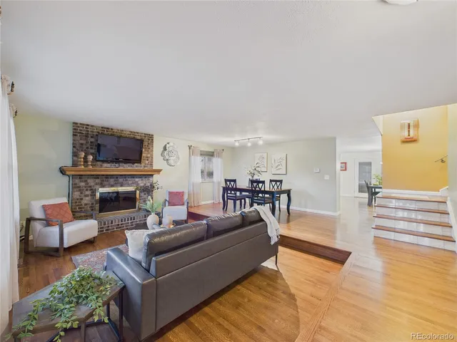 a living room with furniture and paintings on the wall