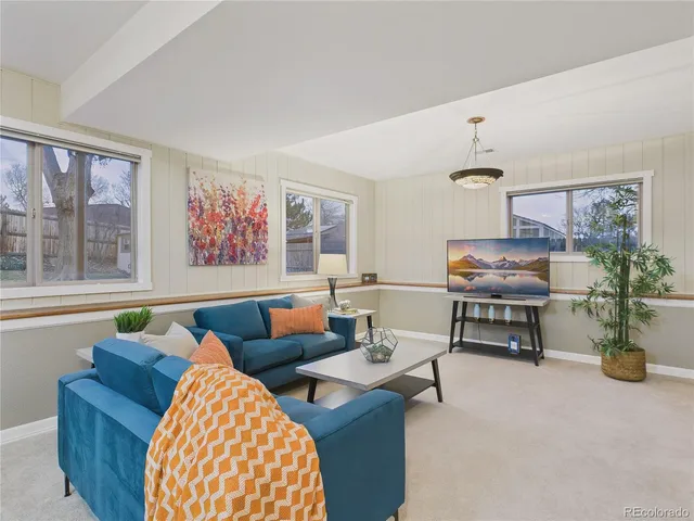a bathroom with a granite countertop sink a toilet and a large mirror