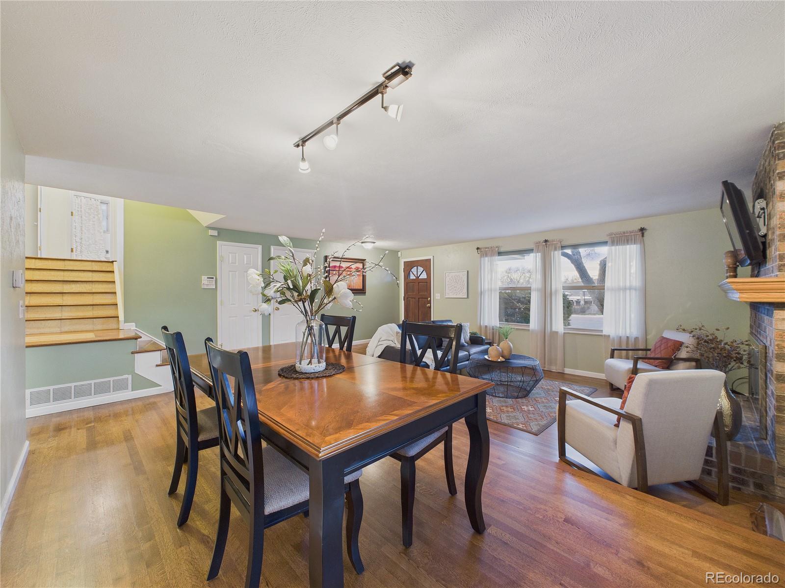 8373 Zephyr Street Arvada, CO 80005 - Photo 9 of 31 a view of a dining room with furniture and wooden floor