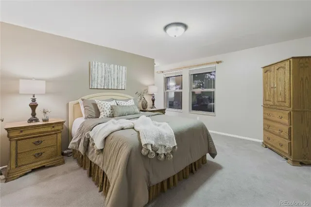 a bedroom with a bed and a painting on the wall