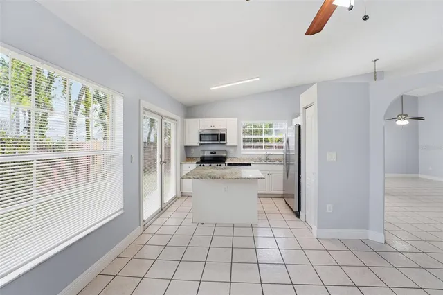 a kitchen with stainless steel appliances a refrigerator and a stove top oven