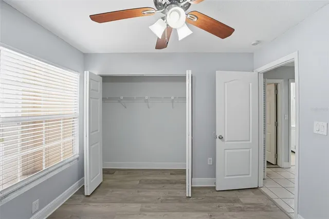 a view of room with window and ceiling fan