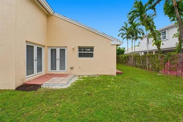 a view of backyard of house with green space