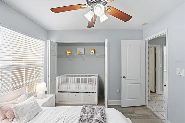 a view of a bedroom with a bed and wooden floor