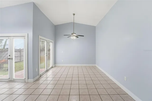 a view of an empty room and window chandelier fan