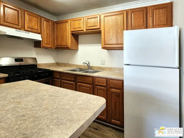 a kitchen with a refrigerator and a sink
