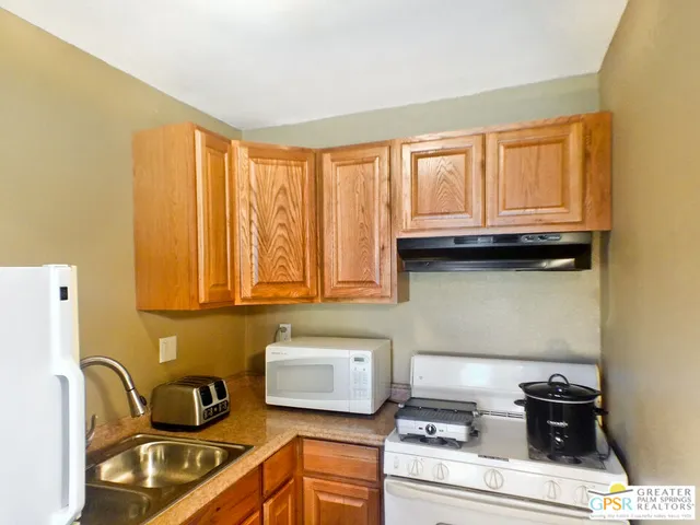 a kitchen with a stove and a cabinet