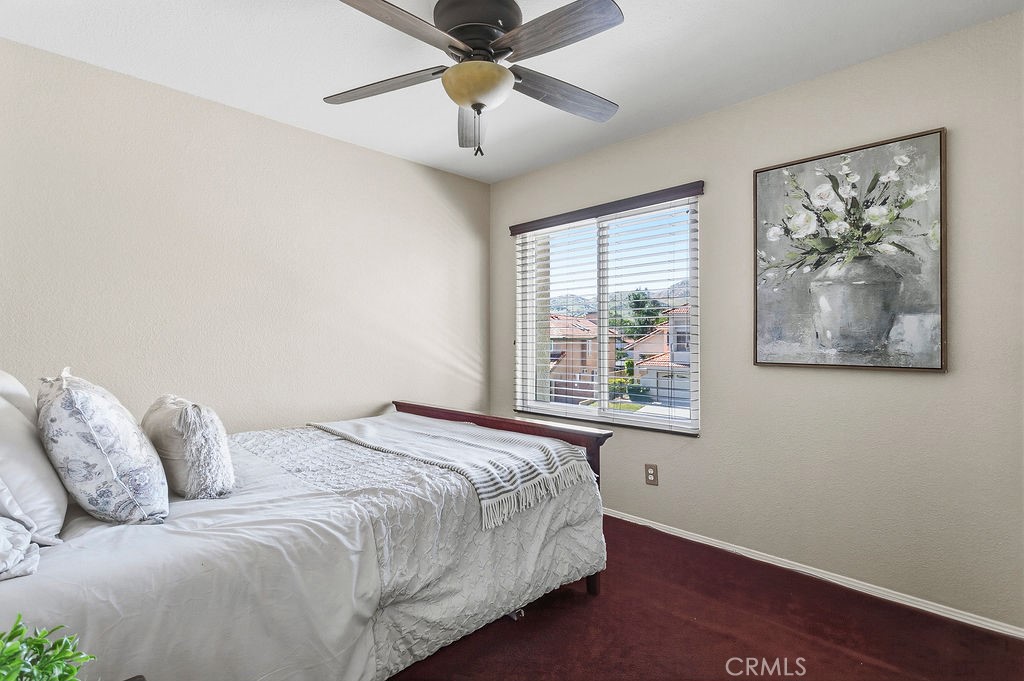 22720 Springmist Drive Moreno Valley, CA 92557 - Photo 19 of 40 a bedroom with a bed and a painting on the wall
