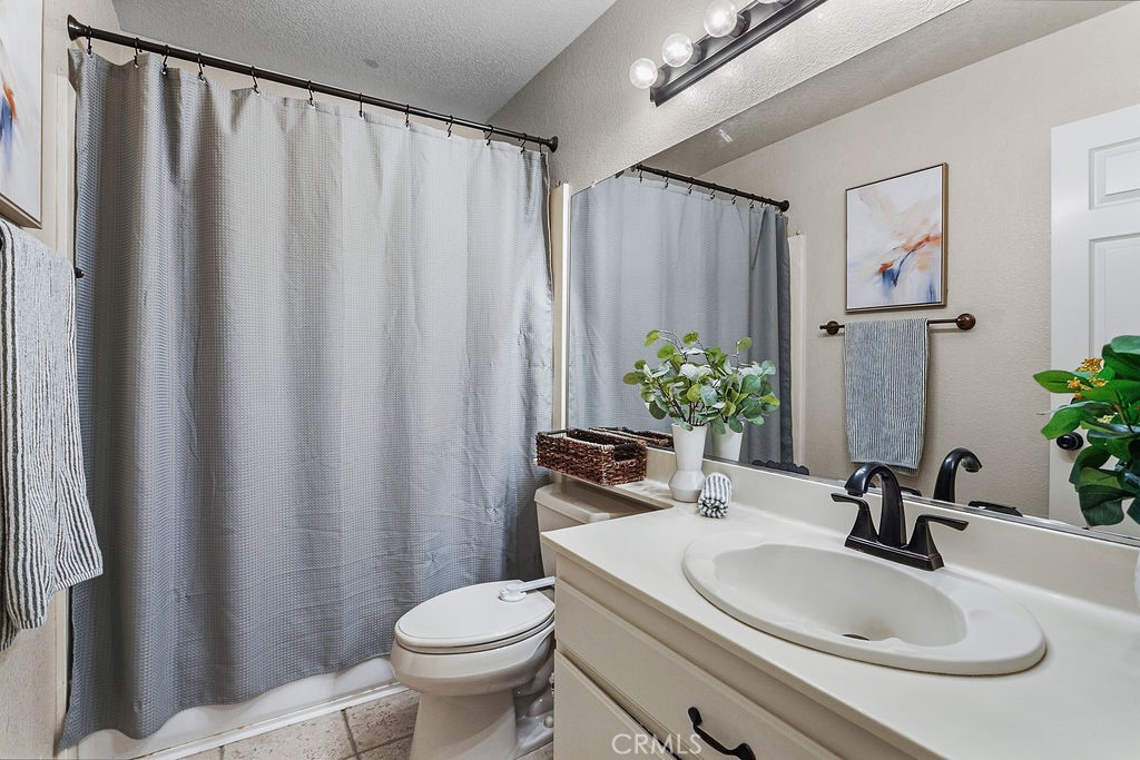 22720 Springmist Drive Moreno Valley, CA 92557 - Photo 20 of 40 a bathroom with a sink toilet and shower