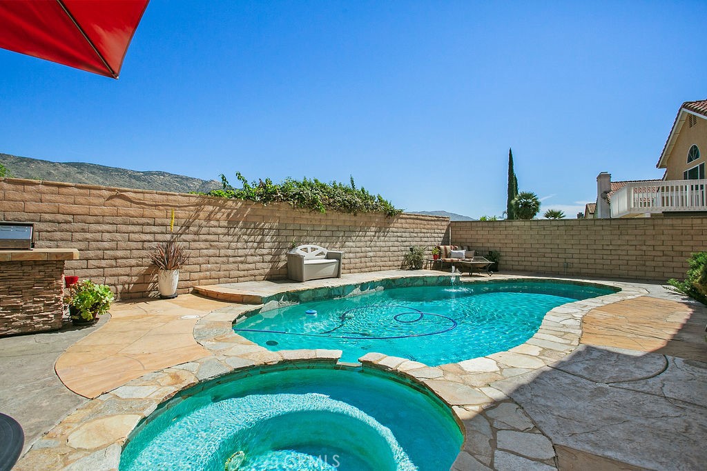 22720 Springmist Drive Moreno Valley, CA 92557 - Photo 2 of 40 a view of a swimming pool with an ocean view
