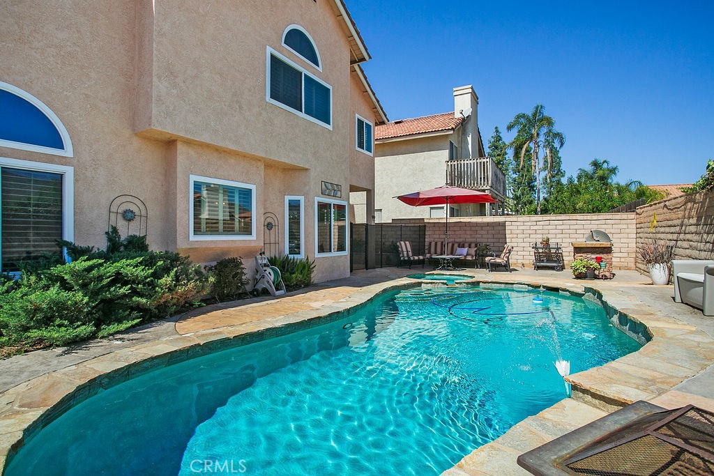 22720 Springmist Drive Moreno Valley, CA 92557 - Photo 25 of 40 a swimming pool with outdoor seating yard and barbeque oven