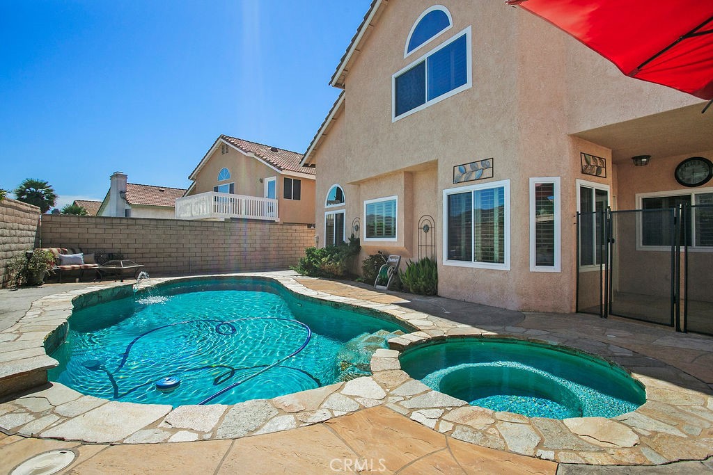 22720 Springmist Drive Moreno Valley, CA 92557 - Photo 27 of 40 a view of a house with a swimming pool