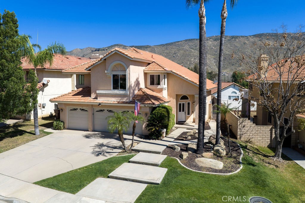 22720 Springmist Drive Moreno Valley, CA 92557 - Photo 31 of 40 a front view of a house with garden